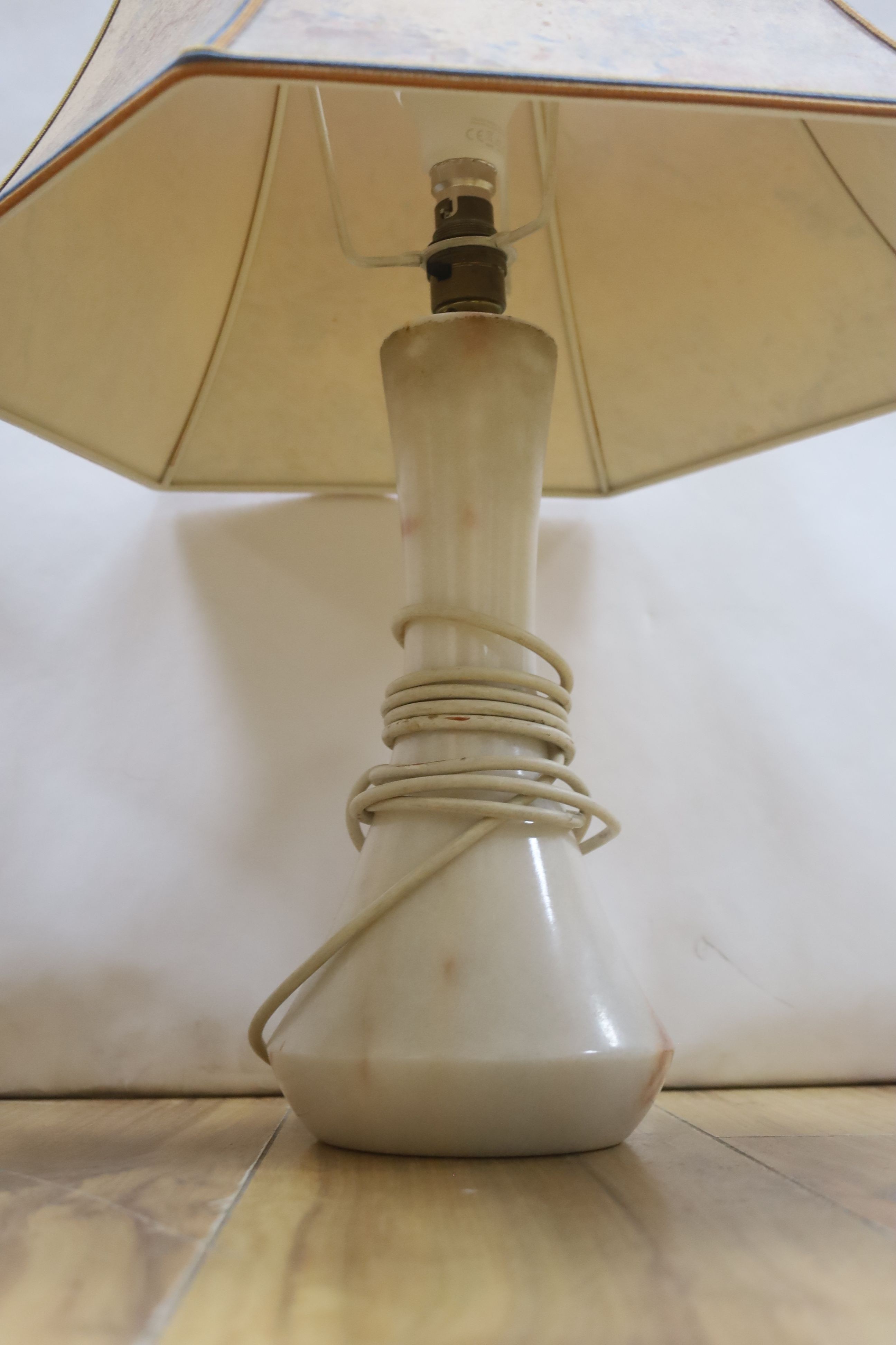 A collection polished stone eggs, dishes and three table lamps and shades.